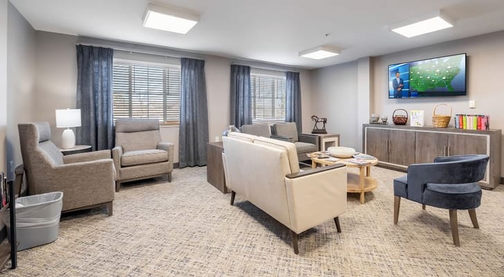 Bright common area with seating and a TV