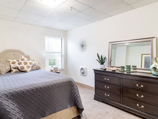 Cozy private resident room with a bed and dresser