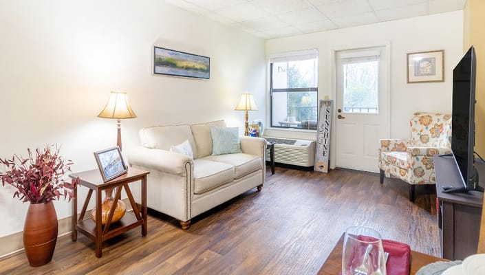 Cozy sitting area in a resident room with natural light