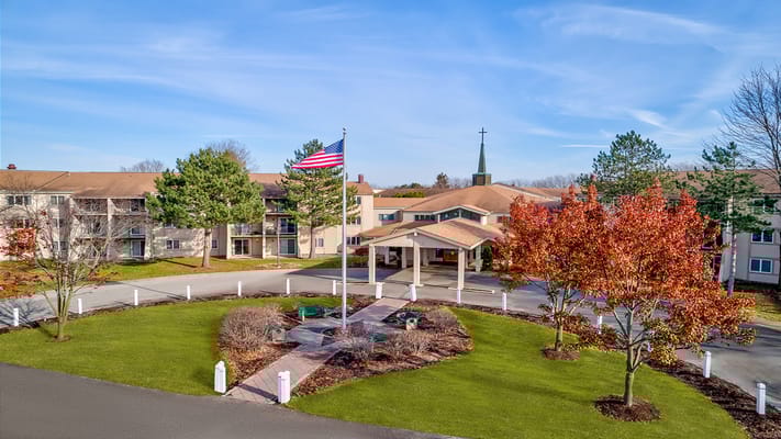 Aerial view of the Holiday Winter Village entrance with flag and landscaping