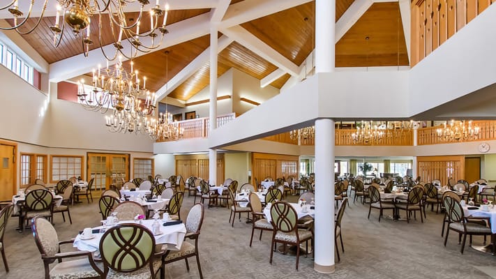 Elegant dining room set for a meal with chandeliers