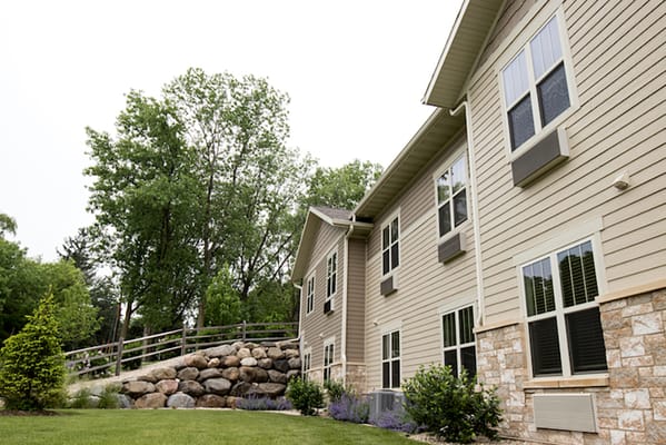 Exterior view of the assisted living facility with greenery