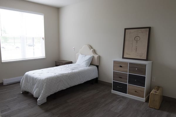 Private resident room with a bed and dresser