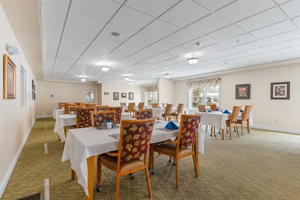 Dining area with tables and chairs set up for a meal