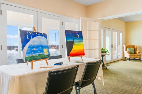 Art supplies set up for a painting class in a bright room