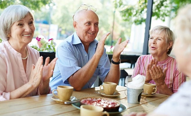 Residents enjoying a gathering with snacks outdoors