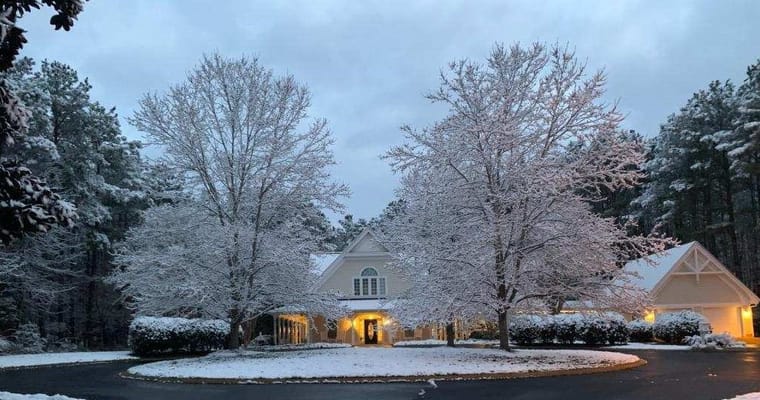 Snow-covered exterior of the facility with trees