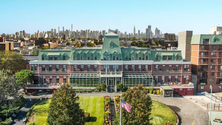 Aerial view of Hudson Hills Senior Living with landscaped grounds.