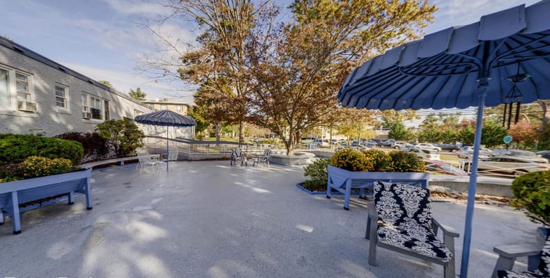 Outdoor seating area with colorful plants and shade