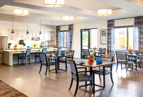Bright and inviting dining room with tables set for meals