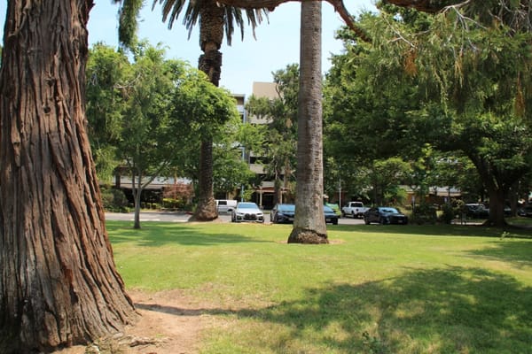 View of the facility with landscaping and parking