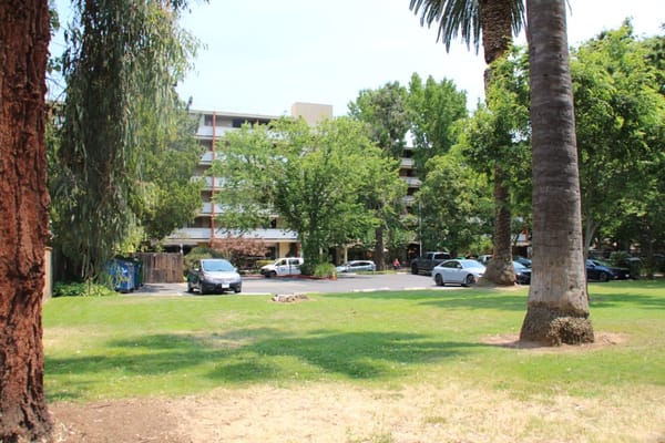 Outdoor view of facility with surrounding trees and parking area
