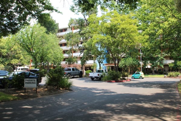 Exterior view of the assisted living facility surrounded by gardens