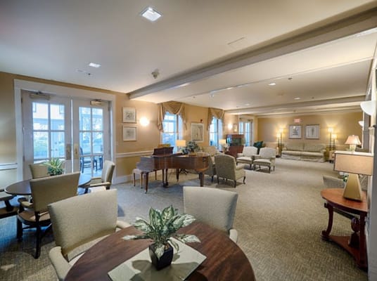 Bright common area with seating and piano