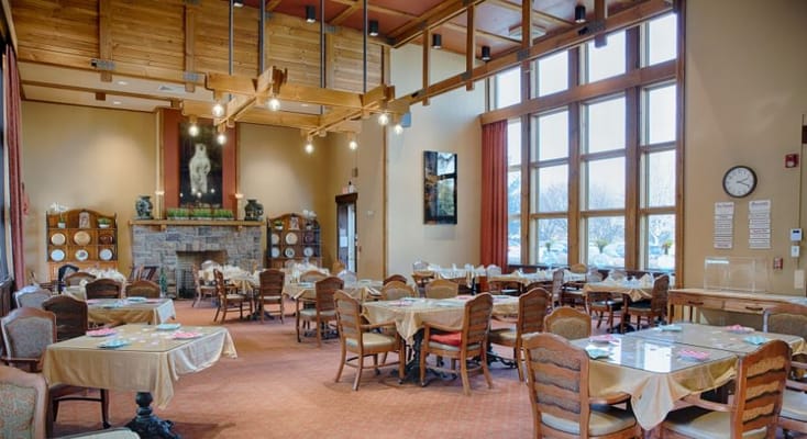 Bright dining area with tables and large windows
