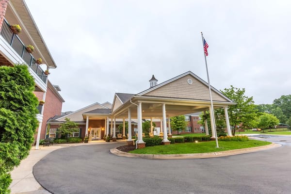 Entrance of Independence Village with flag and landscaping.