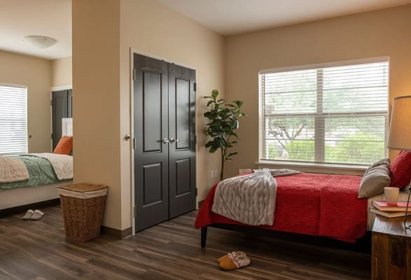 Cozy private room with a bed and window.