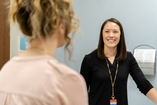 Staff member smiling during a conversation with a resident