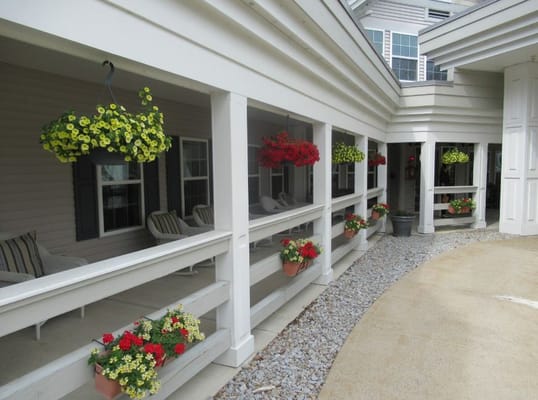 Outdoor area with hanging flowers and seating