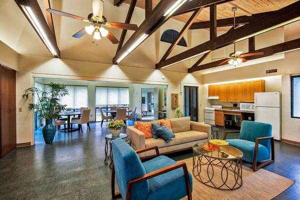 Bright communal lounge with comfortable seating and kitchen area