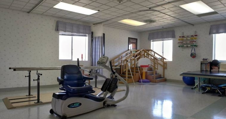 Interior view of a therapy gym with equipment