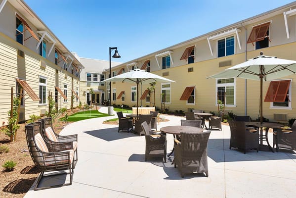 Outdoor courtyard with seating and shade umbrellas