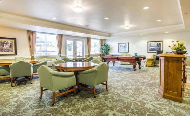 Common area with seating and billiards table in Lakeview Senior Living.