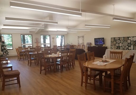 Spacious dining room with wooden tables and chairs