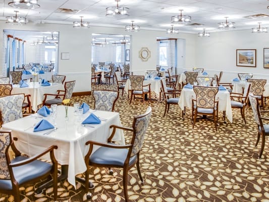 Elegant dining room with tables set for meals
