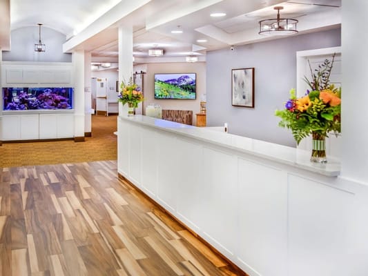 Bright and welcoming common area with flowers and artwork