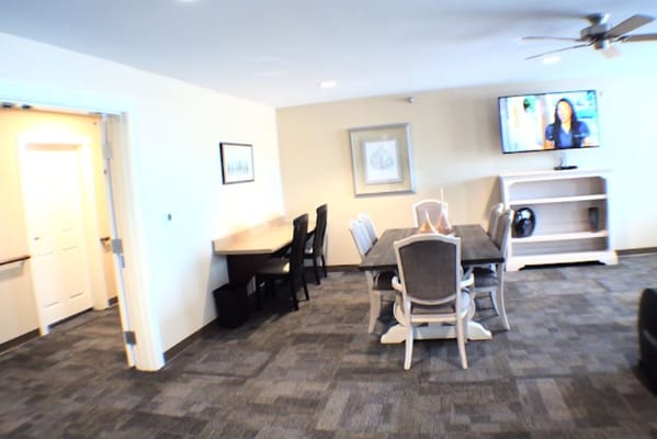 Bright interior common area with seating and a TV