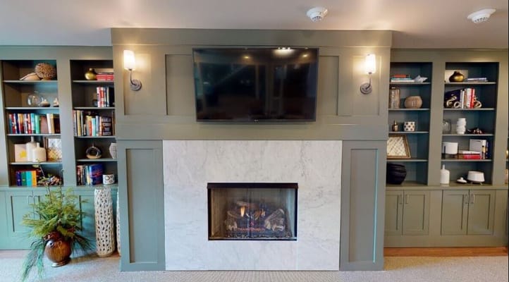 Interior common area with a fireplace and bookshelves