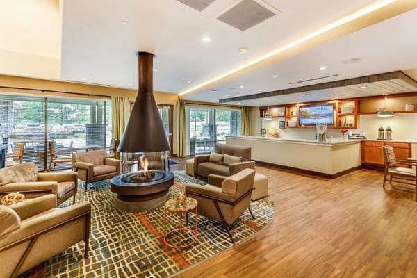 Bright and inviting common area with seating and a fireplace