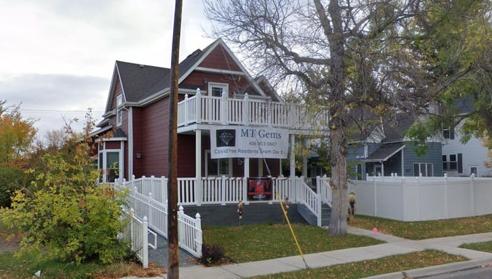 Exterior view of MT Gems – Ruby House with a sign.