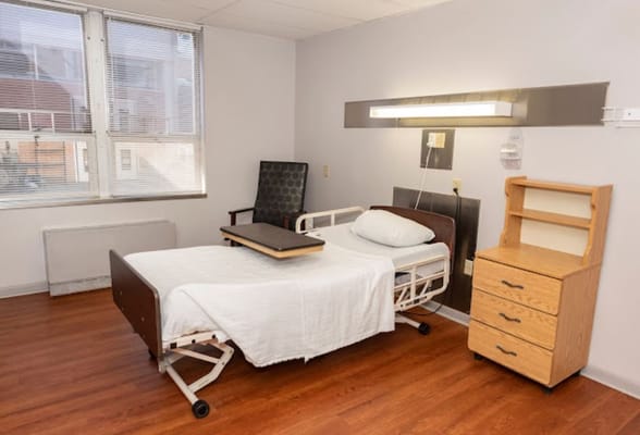 A private resident room with a hospital bed and furniture