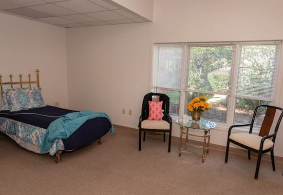 Cozy private room with bed and seating area