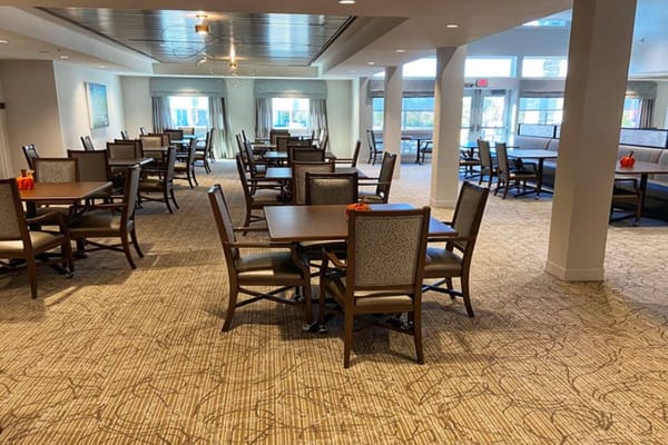 Bright dining area with wooden tables and chairs