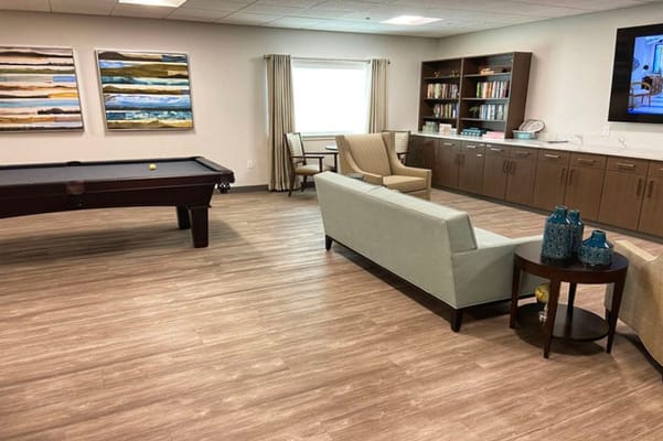 Interior of a common area with seating and a pool table