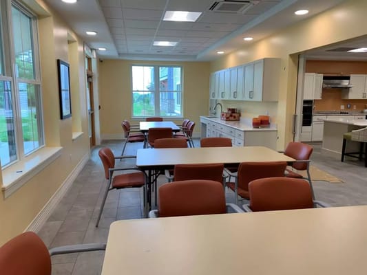 Bright common area with tables and chairs set up