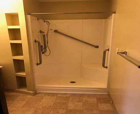Spacious accessible shower with grab bars