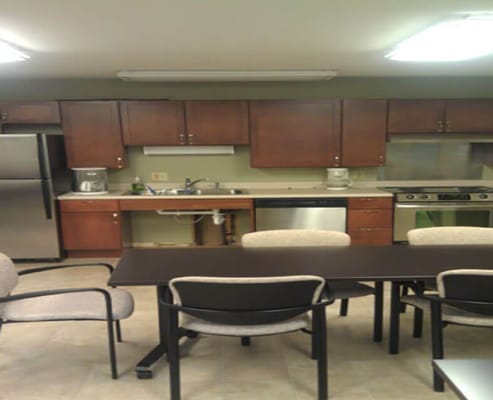 Modern kitchen with appliances and dining table.