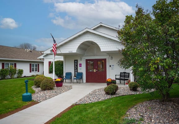 Front entrance of Marla Vista Assisted Living with flower pots and seating