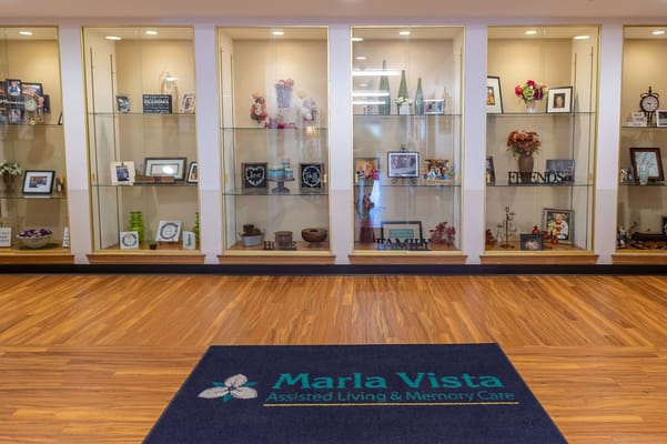 Glass display showcasing photos and decor in the lobby