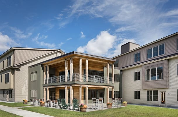 Exterior view of a nursing home with outdoor seating