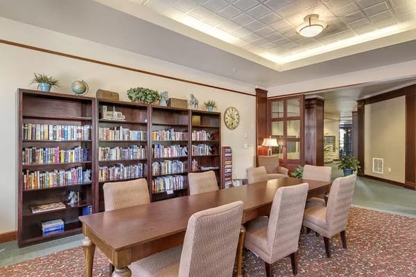 Interior common area with a bookshelf and dining table
