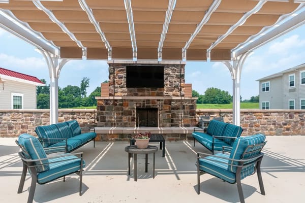 Outdoor seating area with stone fireplace
