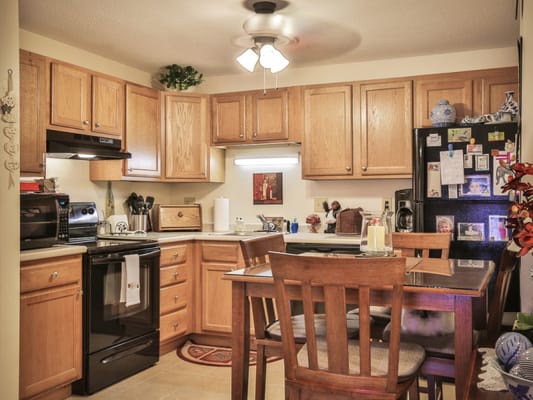 Bright kitchen area with wooden cabinets and dining table