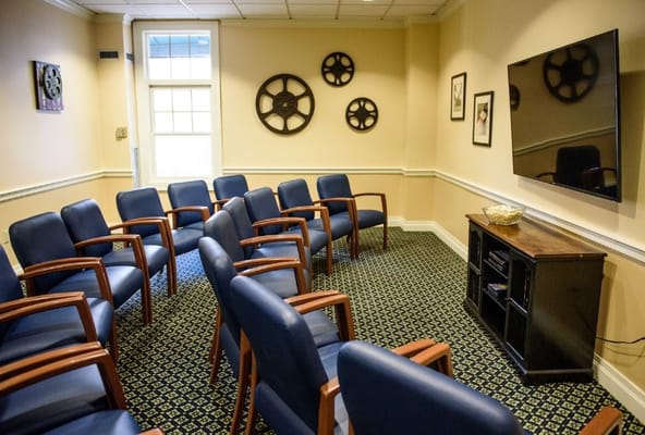Seating arrangement in a cozy room with a television and decorative wall accents.
