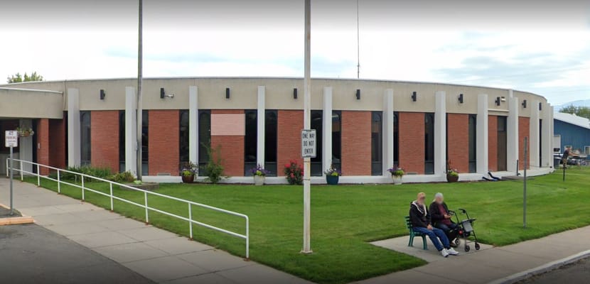 Residents sitting outside the facility on a sunny day