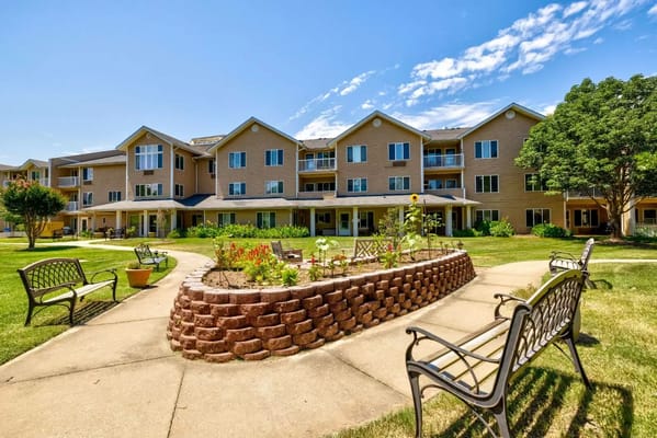 Exterior view of a senior living facility with gardens